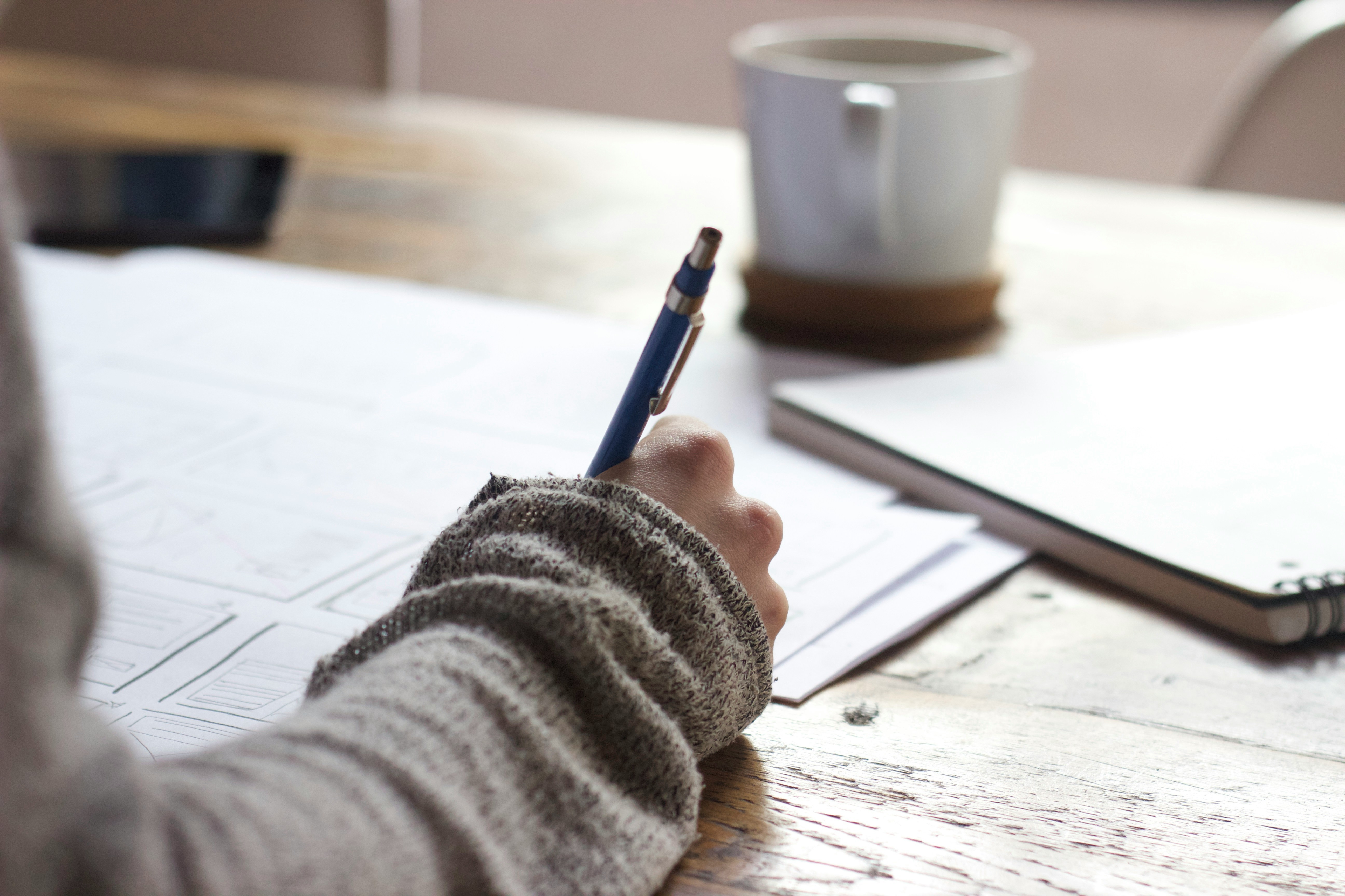 Bookkeeper working at her desk with a cup of coffee.